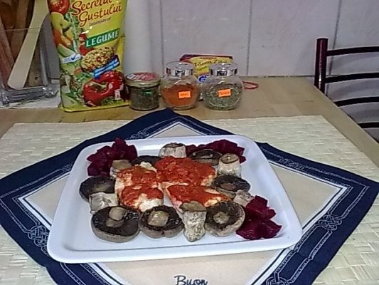Piept de pui pe pat de rosii cu ciuperci champignion.